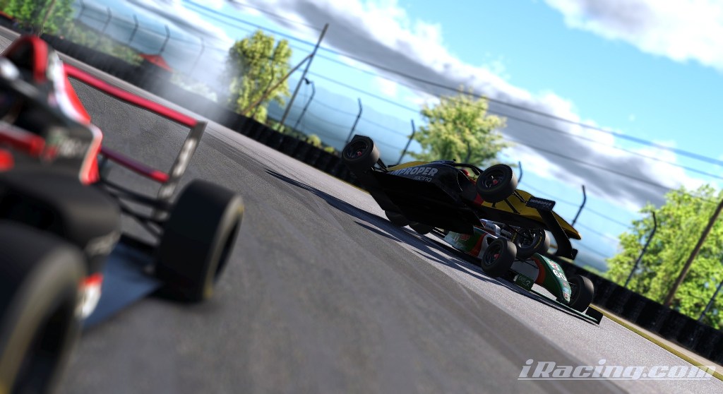 Two racing cars on a track, one airborne after a collision, showcasing the intensity of the race at Mid-Ohio Sports Car Course.