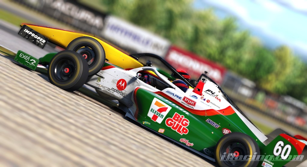Close-up of a green and white race car, number 60, with yellow accents and 'Improper' branding on the rear wing, on a racetrack with blurred background trees.