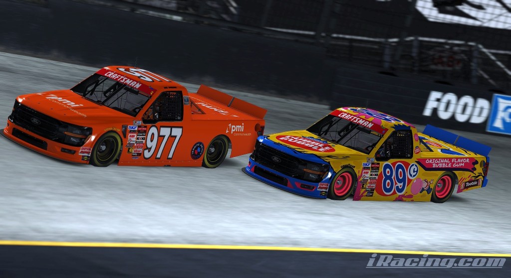 Two racing trucks in a competitive positioning on a track, with the truck numbered 977 in orange and the truck numbered 89 in a colorful bubble gum design.