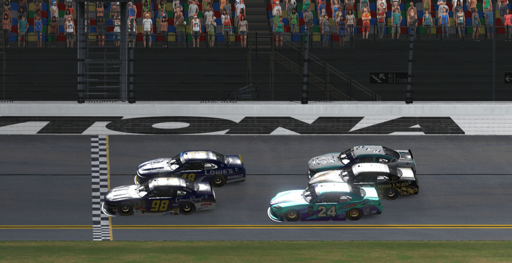Close finish of a car race at Daytona International Speedway with several cars crossing the finish line.